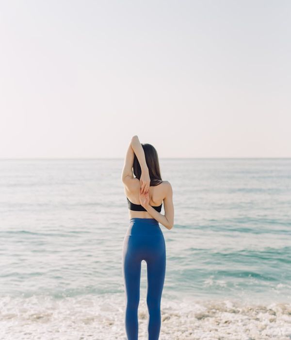 Person stretching outdoors, feeling energized by the morning sun.